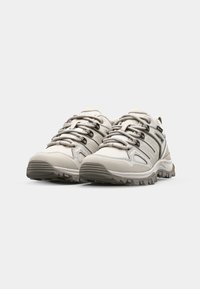 Light gray hiking shoes with textured material, reinforced toe caps, and gray laces. Features a rugged sole with visible tread pattern.