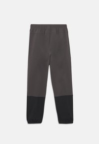 Σκούρο γκρι αθλητικό παντελόνι με μαύρο κάτω τμήμα· ελαστική ζώνη μέσης· στενά πόδια· λείο, ελαφρύ ύφασμα.