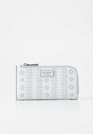 White leather wallet featuring laser-cut floral designs and perforations, silver-tone hardware, and a top zipper closure.