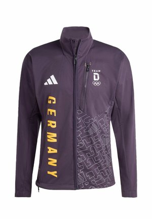 Giacca sportiva viola con colletto alto, scritta gialla "GERMANIA", diversi loghi e motivo decorativo su un lato. Tasca frontale con cerniera inclusa.