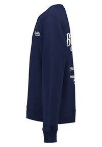 Sudadera azul marino con puños y dobladillo acanalados, que presenta texto y logotipos en color blanco. Fabricada en un tejido suave y texturizado, diseñada para brindar comodidad.