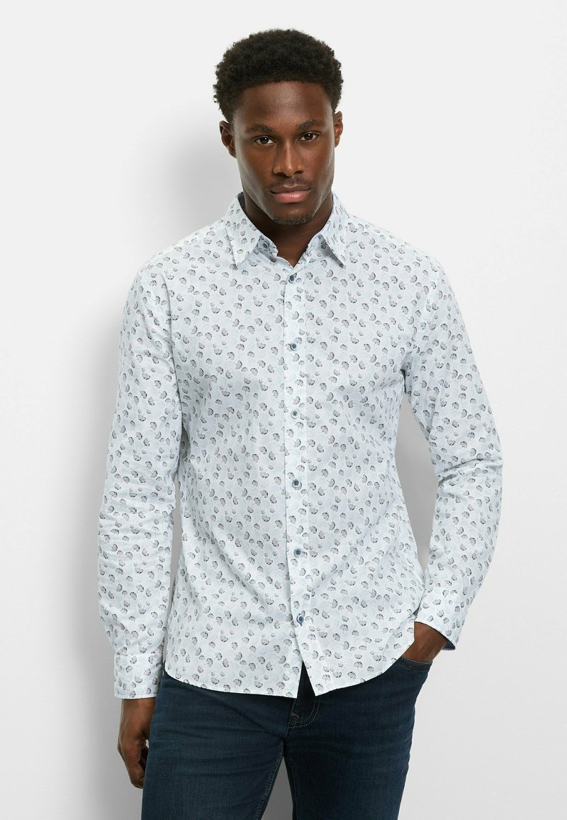 Light blue long-sleeve shirt with a small, repeated dark pattern. Features a button-down collar and light buttons, made from woven fabric.