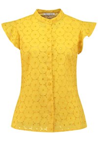 Yellow embroidered shirt with a mandarin collar, short cap sleeves, floral pattern, and button closure. Features decorative eyelet cutouts at the hem.