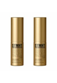 Two gold spray powder containers, cylindrical shape, with black text detailing product information and usage instructions.