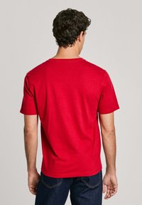 Rød kortærmet t-shirt lavet af bomuld, med rund hals og et enkelt design. Set fra ryggen med en glat tekstur.
