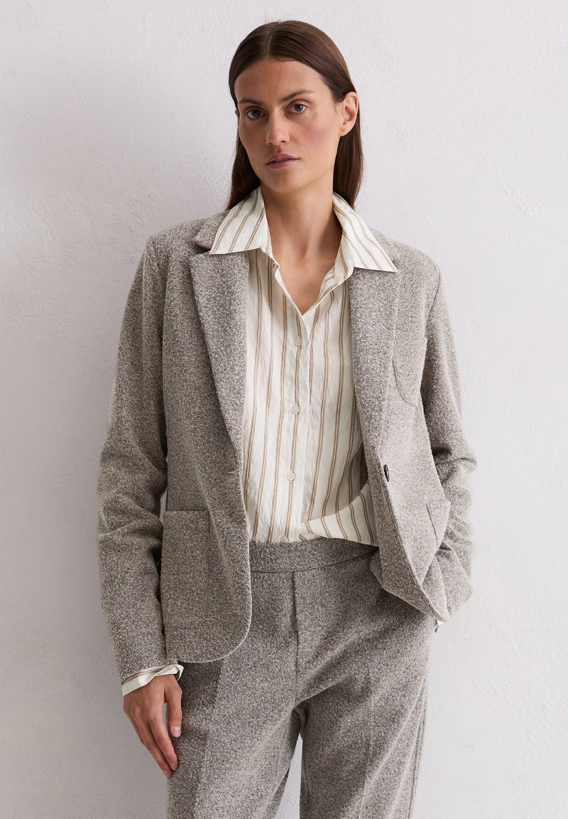 Gray textured blazer with lapels and front pockets, paired with a light striped button-up shirt. Simple, tailored design.