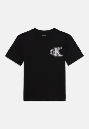 Black cotton t-shirt with short sleeves, featuring a prominent white embroidery of "CK" on the left chest area and a classic crew neck design.