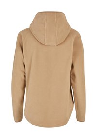Veste en polaire beige avec capuche, manches longues et ourlet arrondi, vue de dos sur fond blanc.