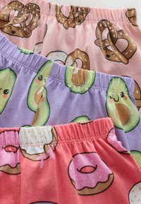 Three pairs of multicolored cotton shorts with elastic waistbands. Patterns: pink with pretzels, lavender with avocados, and coral with donuts.
