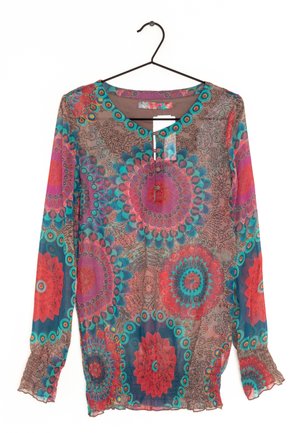 Pitkähihainen pusero, jossa moniväriset pyöreät kukkakuviot punaisena, petroolinvärisenä, violetina ja ruskeana kevyellä kankaalla, mustalla vaateripustimella ripustettuna.