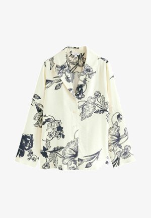 White shirt with black floral pattern, featuring a notched collar, button front, and wide sleeves. Soft fabric with a smooth texture.
