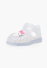 Clear plastic sandal with a translucent sole, open design, and a pink Hello Kitty face accent on the toe. Features strap for secure fit.