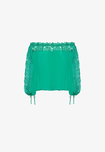 Zöld, vállon kívüli blúz, csipke díszítéssel az ujjakon, elasztikus nyakkivágással és állítható megkötőkkel a mandzsettán. Sima anyagtextúra.