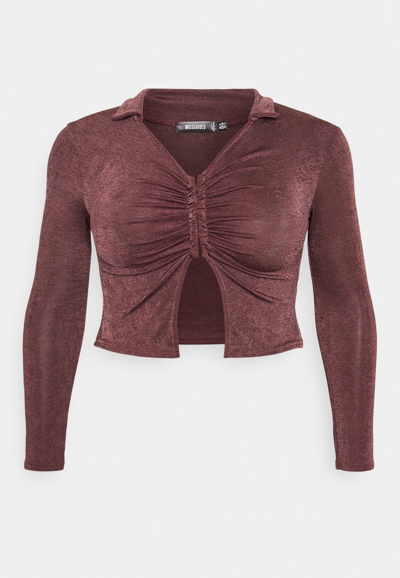 Blusa de mangas longas vermelha rubi com gola, detalhes franzidos na frente e um corte aberto abaixo do busto. Tecido suave e com brilho.