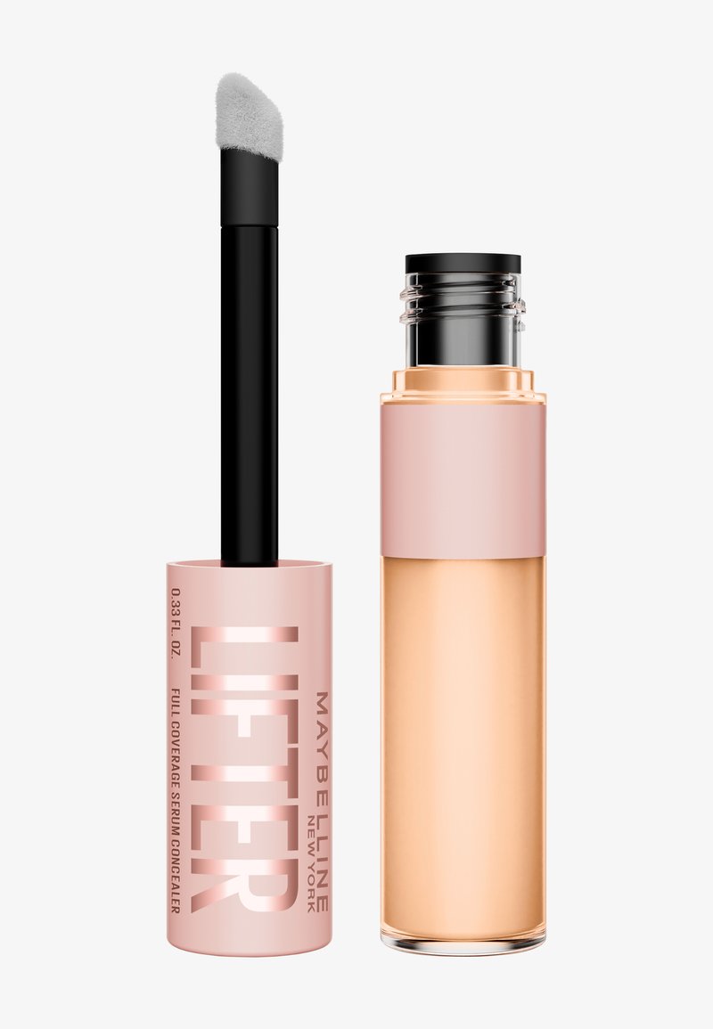 Maybelline Lifter Full Coverage Serum Concealer in a pink tube with black applicator, paired with a clear glass bottle with a gold accent.