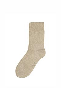 Beige bomullssokk med et enkelt design, ribbestrikket tekstur på toppen, og forsterket tå og hæl for holdbarhet.