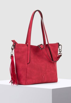 Czerwona ażurowa torba na ramię z podwójnymi uchwytami, srebrnymi okuciami i detalem w formie frędzla, z otwartym wierzchem i tłoczonym logo po boku.