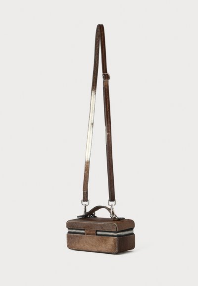 Brown leather crossbody bag with a boxy design, featuring a zip closure, adjustable strap, and silver hardware accents.