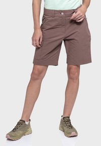 Braune Cargo-Shorts mit umgeschlagenem Saum, ausgestattet mit Seitentaschen und einem Knopfverschluss. Hergestellt aus strapazierfähigem, leichtem Stoff.