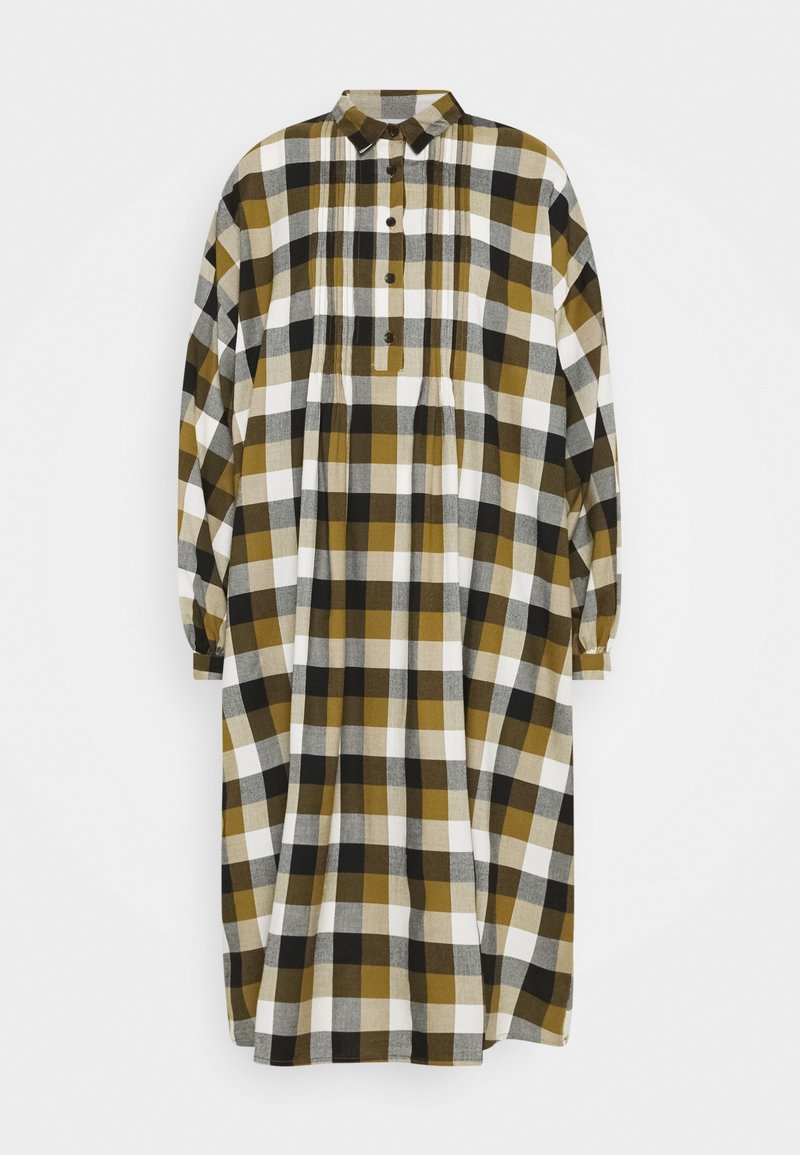 Robe chemise à manches longues avec col, présentant une coupe ample et un grand motif à carreaux dans des tons moutarde, noir, blanc et gris.