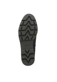 Black rubber shoe sole with zigzag tread pattern and raised heel. Textured surface for grip, marked with "Vionic" and certification symbols.