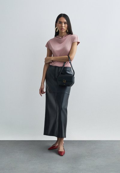 Pink short-sleeve top, black faux leather long skirt, red pointed flats. Small black handbag with gold hardware accents. Simple, modern design.