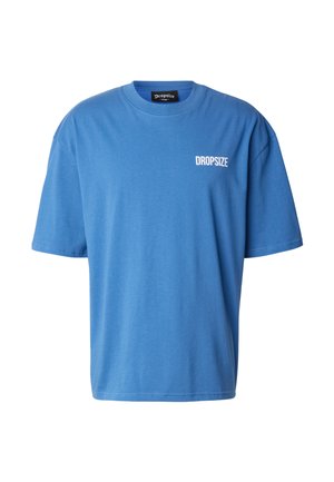 T-shirt bleu surdimensionné à manches courtes avec le texte blanc « DROPSIZE » sur la poitrine gauche et un col rond.