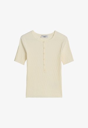 Kremowy prążkowany krótki sweter z okrągłym dekoltem i zapięciem na guziki z przodu, z markową metką wewnątrz kołnierza.