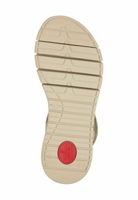 Tan rubberen zool met een gestructureerd loopvlakpatroon. Kenmerkt zich door een rode cirkelvormige logo met het label "Comfort." Maat 37 gemarkeerd aan de zijkant.