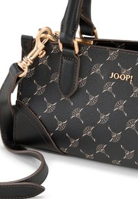 Black leather handbag with light-patterned accents, gold hardware, and structured shape. Features detachable shoulder strap and textured surface.