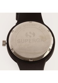 Black silicone watch with a round stainless steel back, featuring "SUPERGA" engraved and "WATER RESISTANT 3 ATM" inscribed.