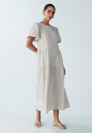 Cream and beige striped maxi dress with puffed short sleeves, tiered design, and a round neckline. Lightweight, casual fabric.