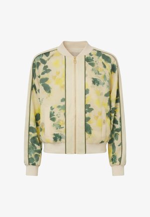 Giacca bomber beige chiaro con cerniera, motivo floreale verde e giallo, polsini e cinturino a costine, e rifiniture verdi sulle maniche e sul davanti.