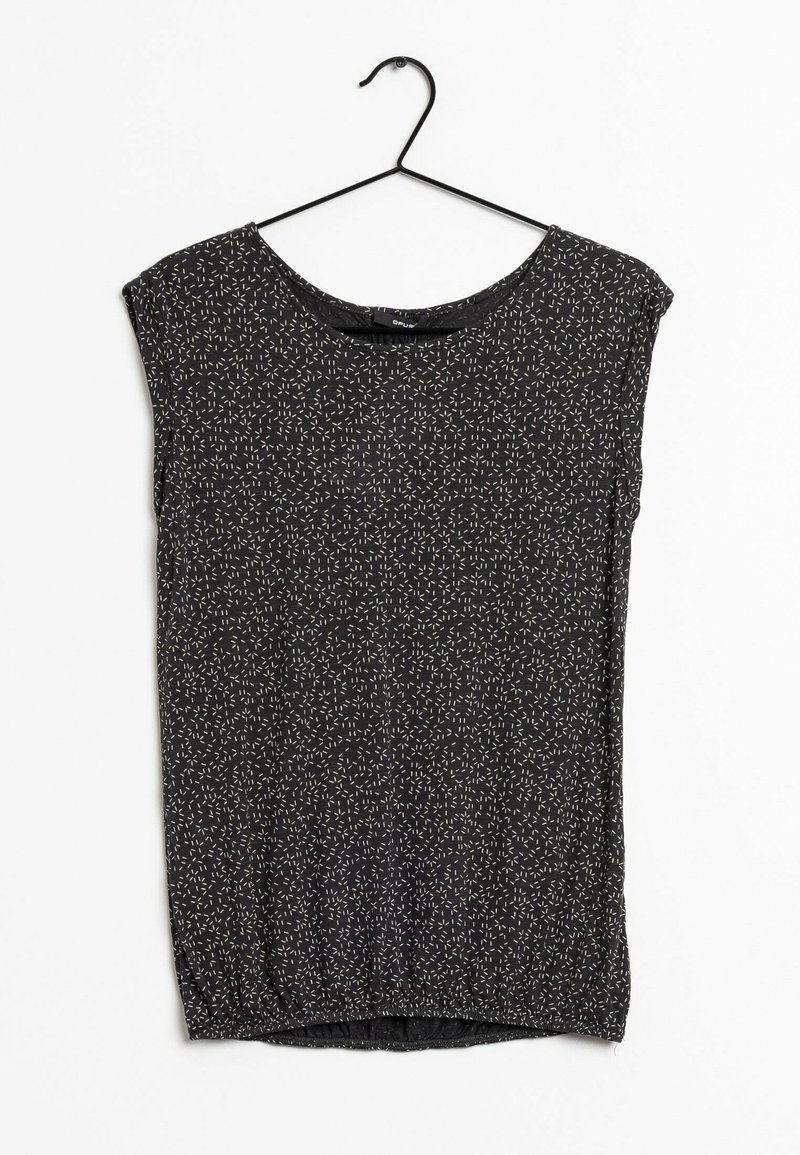 Haut noir sans manches avec un petit motif de traits blancs, suspendu sur un cintre noir sur fond blanc.