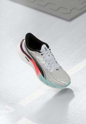 Lightweight running shoe in grey mesh, featuring a black collar, colorful accent on heel, and a cushioned sole with mint green and coral details.
