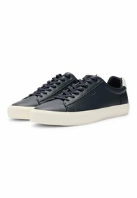 Navy leather sneakers with a textured finish, white rubber soles, and matching laces. Features a low-top design and padded collar.