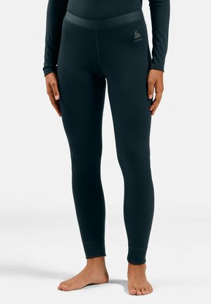 Black leggings made of stretch fabric, featuring a high waistband and a fitted silhouette. Subtle logo detail near the hip. Smooth texture.