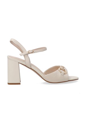 Beige leather heeled sandals with a square toe, block heel, and ankle strap. Features a gold accent buckle on the front.