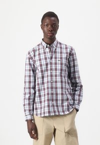Long-sleeve shirt in a red and blue plaid pattern, made of cotton fabric, featuring a button-down collar and a subtle logo on the chest.