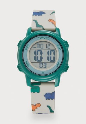 Orologio digitale con cassa in plastica turchese e cinturino bianco con motivi colorati di dinosauri. Il display mostra l'ora digitale, la data e i pulsanti.