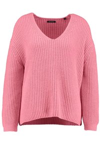 Pull en maille rose avec col en V, manches longues et texture côtelée, doté d'un ourlet légèrement plus long à l'arrière.