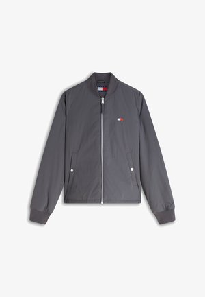 Giacca bomber grigia con chiusura a zip, polsini e colletto a coste, due tasche anteriori con bottoni a pressione e piccolo logo Tommy Hilfiger sul petto.