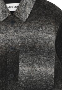 Chaqueta de mezcla de lana en gris y negro con un patrón de cuadros, que presenta un cuello, un bolsillo frontal y botones negros. Acabado suave y texturizado.