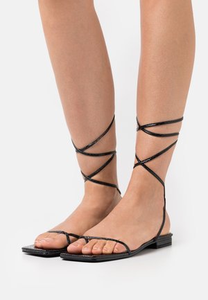 DOLLI - T-bar sandals - black