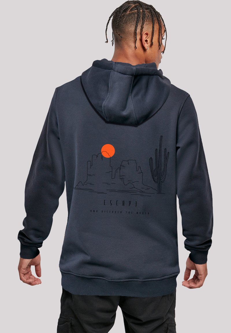 Navy blue hoodie with a front kangaroo pocket, featuring a graphic of a desert landscape and sunset on the back.