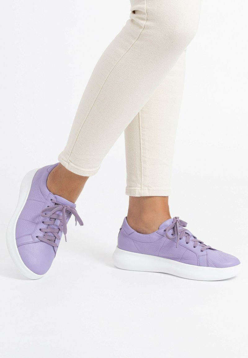 Purple leather sneakers with a smooth texture, rounded toe, and white sole. Features laces and subtle stitching details.