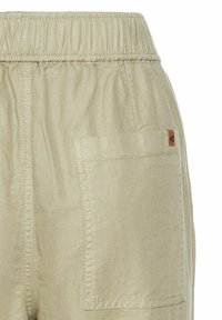 Beige bomuldsbukser med elastisk talje, sidelomme og et lille læderlogo. Stoffet har en glat overflade og en subtil glans.