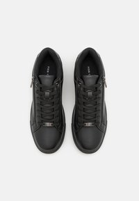 Schwarze Ledersneaker mit glatter Oberfläche, ausgestattet mit Schnürsenkeln, einem Reißverschlussdetail und einem dezenten Muster an den Seiten. Gummisohlen.