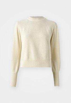 Pull crème avec un motif de tricot texturé, des poignets et un ourlet côtelés, et un col rond. Présente des manches structurées légèrement bouffantes.