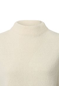Knitted turtleneck sweater in soft cream color, featuring a ribbed texture, fitted collar, and smooth body with a slightly relaxed fit.